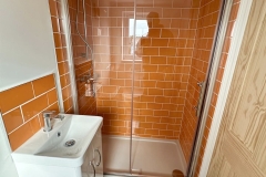 Orange tiled shower room and toilet