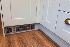 Integral heater under kitchen cabinet