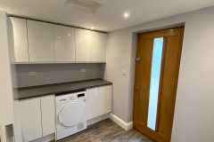 Garage conversion area with washing machine and work surface