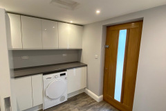 Garage conversion area with washing machine and laundry room space