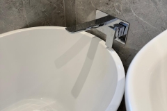 Contemporary, white ceramic bath with chrome mixer tap